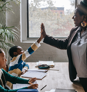 Teacher high-fiving a student